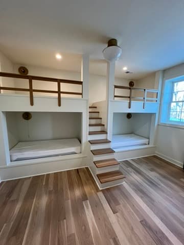 Custom built-in bunk beds with storage stairs for a Kansas City kids room