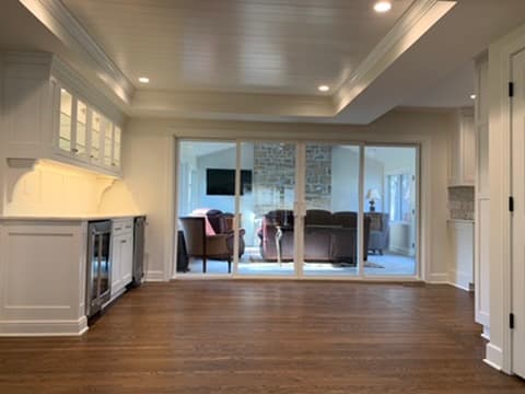 Open-concept living area with a layered tray ceiling and custom crown molding
