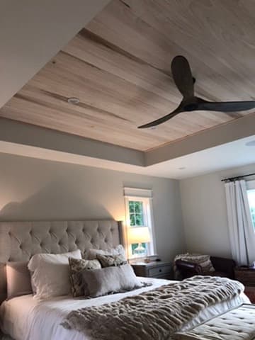 Bedroom with a wood plank accent ceiling and a modern ceiling fan